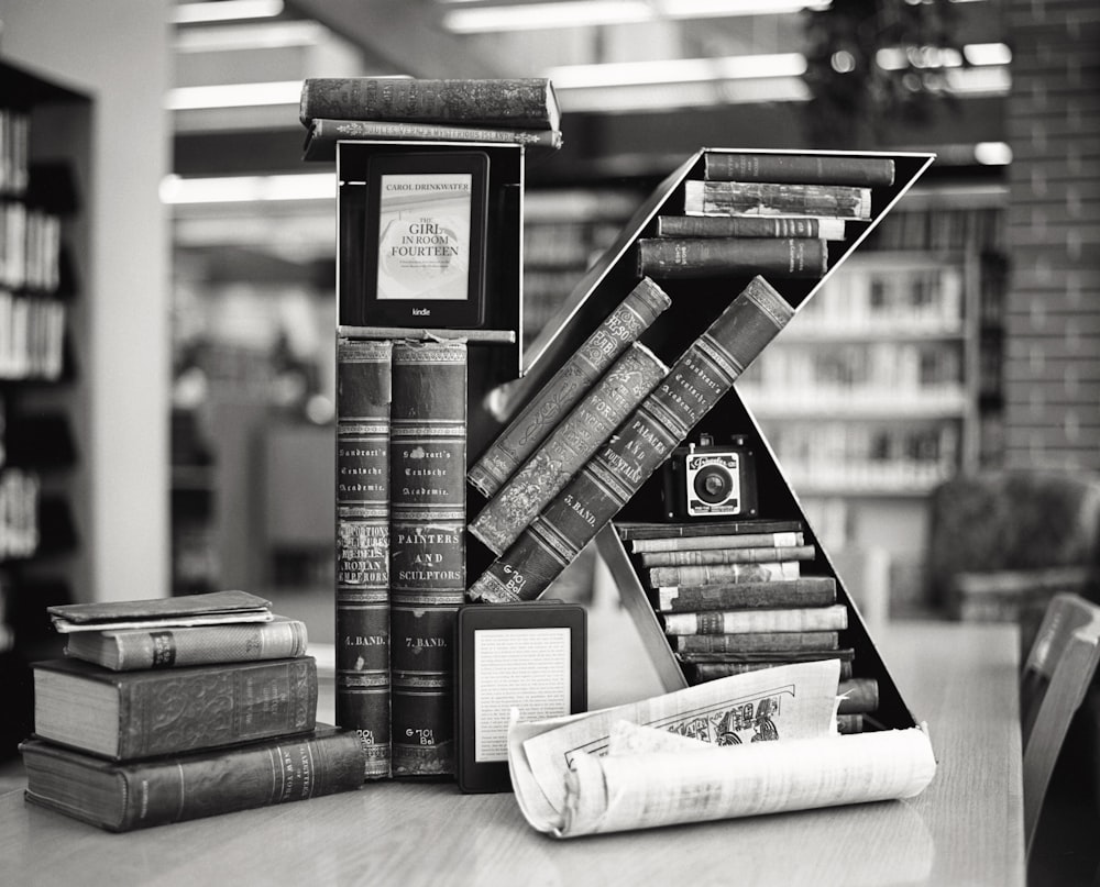 grayscale photo of books on shelf