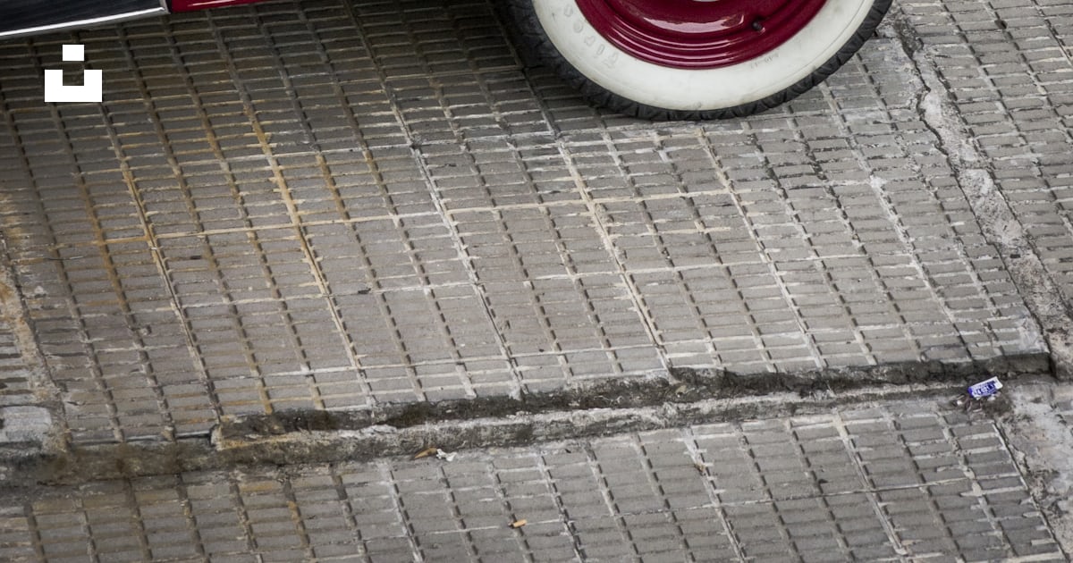 Red classic car on gray brick pavement photo – Free Brown Image on Unsplash