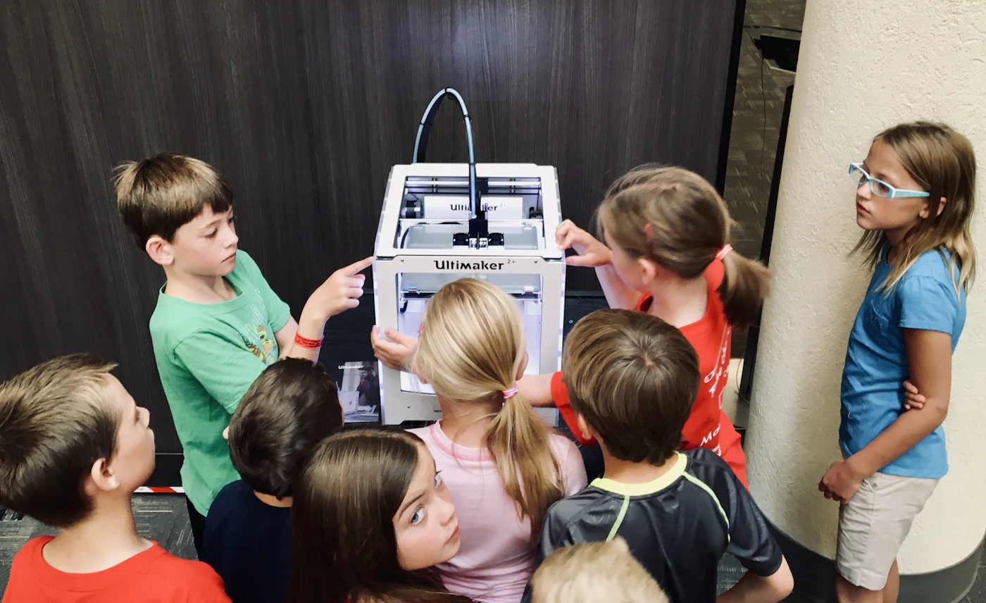Children building and programming a small robot together at a Robotix workshop