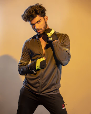 Young entrepreneur proudly holding a prototype of his sportswear design.