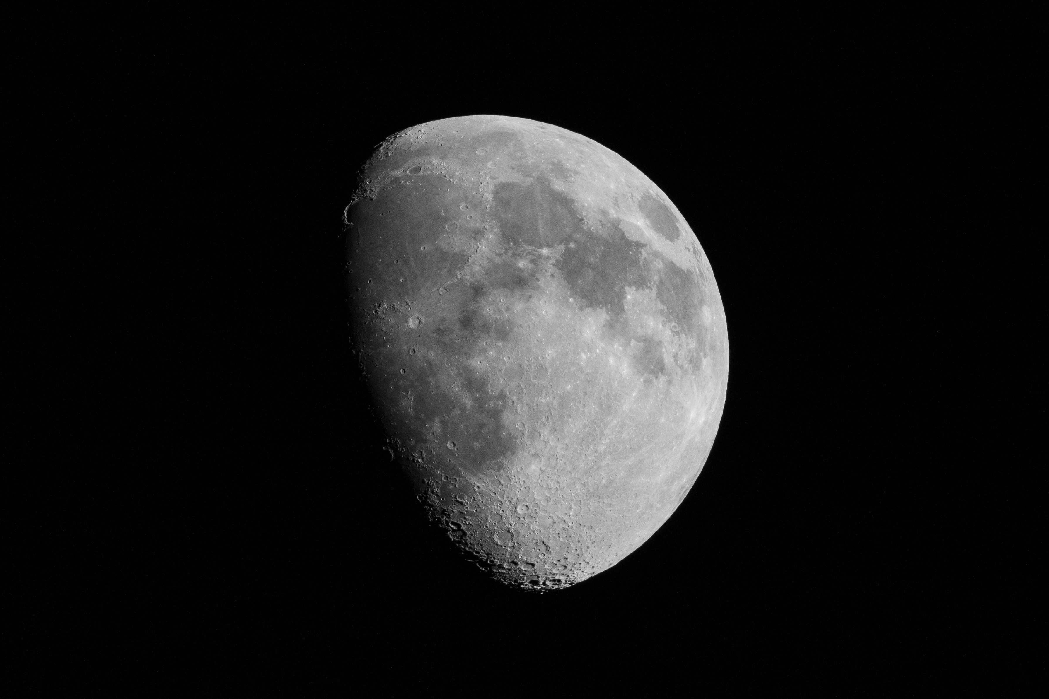 High definition close up of an inverted teardrop shapped gibbous moon centered in a black sky background