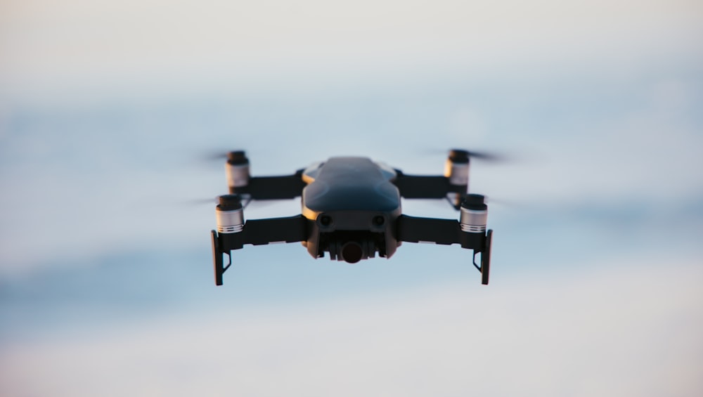 gray and black drone in mid air