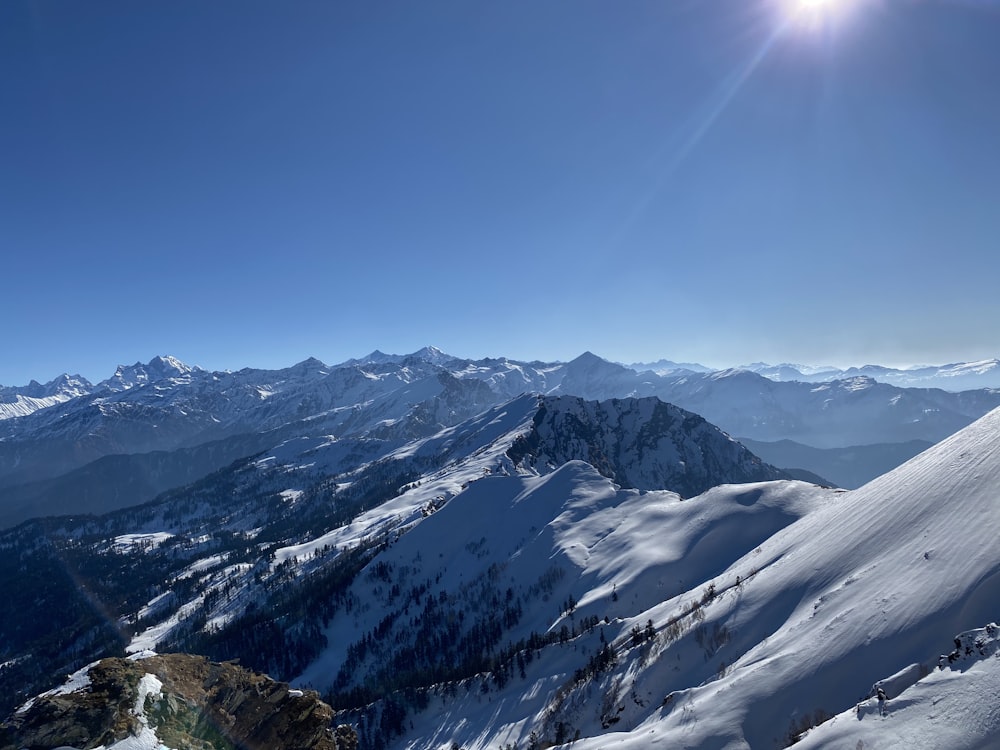 snow covered mountains under blue sky during daytime