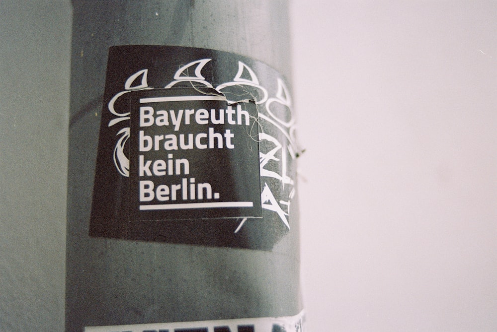 a close up of a street pole with a sticker on it