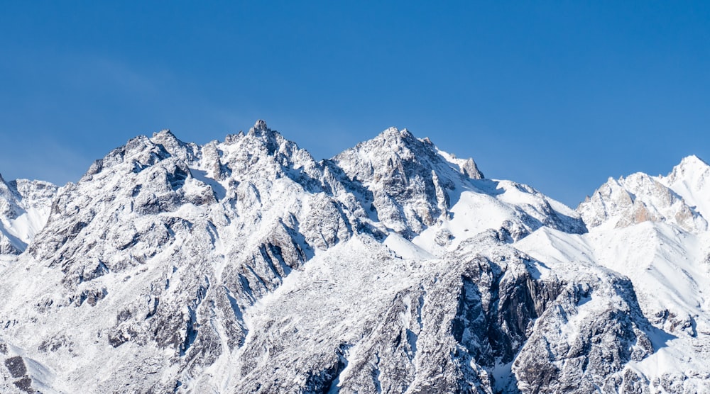 snow covered mountain under blue sky during daytime