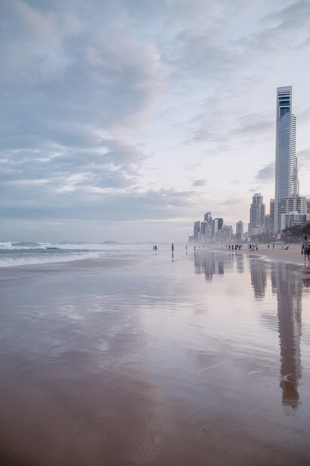 city skyline under white clouds and blue sky during daytime