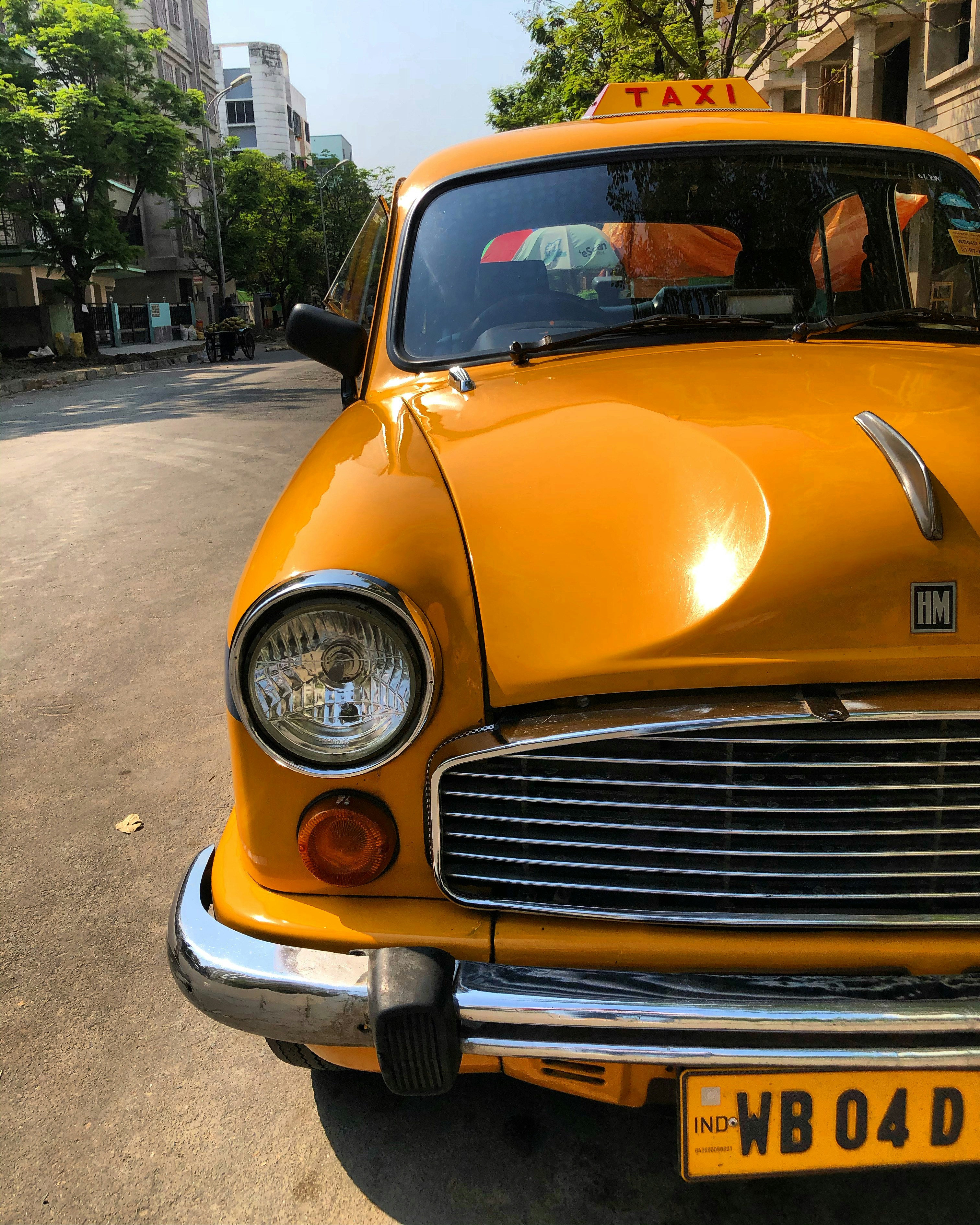 yellow car parked on the side of the road during daytime