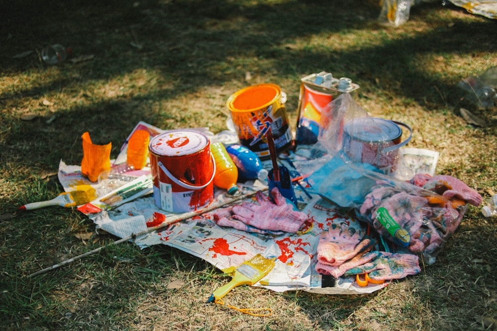 orange plastic bucket on white and red textile