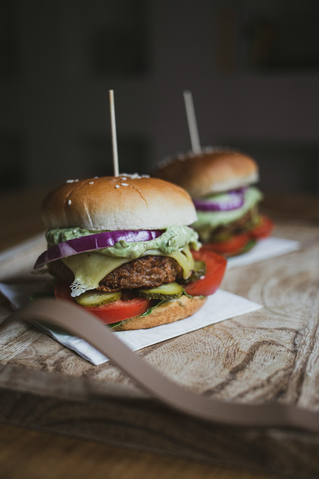 couple of home-prepared vegan beyond burgers with avocado mash