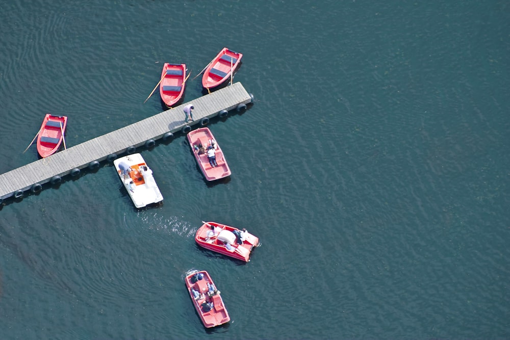 white and red boat on body of water during daytime