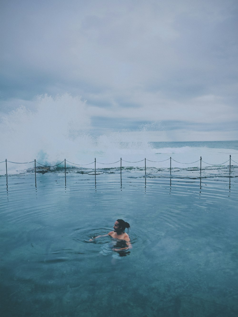 woman in blue bikini swimming on water