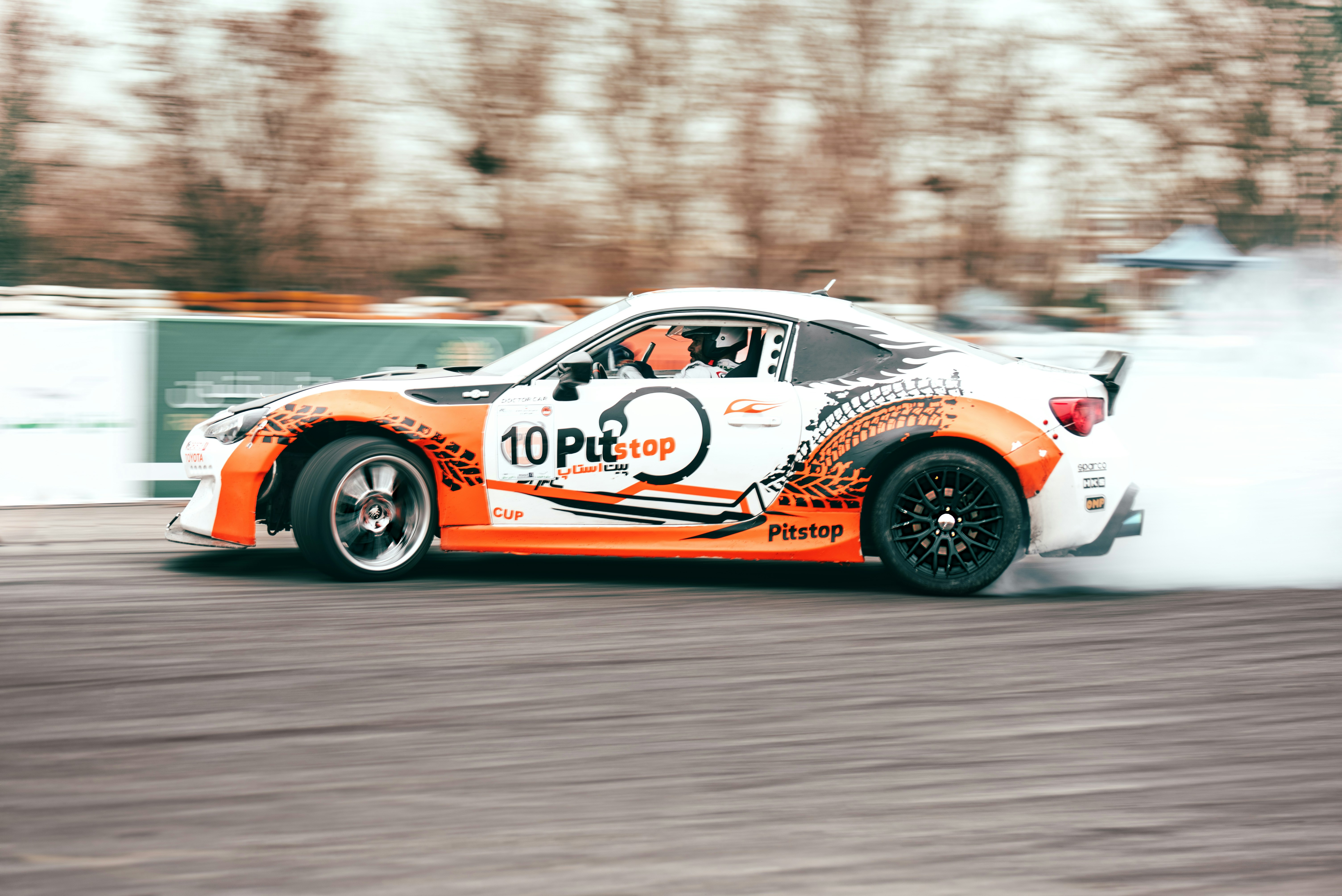 white and red porsche 911 on road during daytime