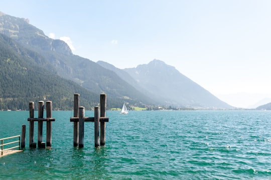 brown wooden dock on body of water during daytime in Pertisau Austria