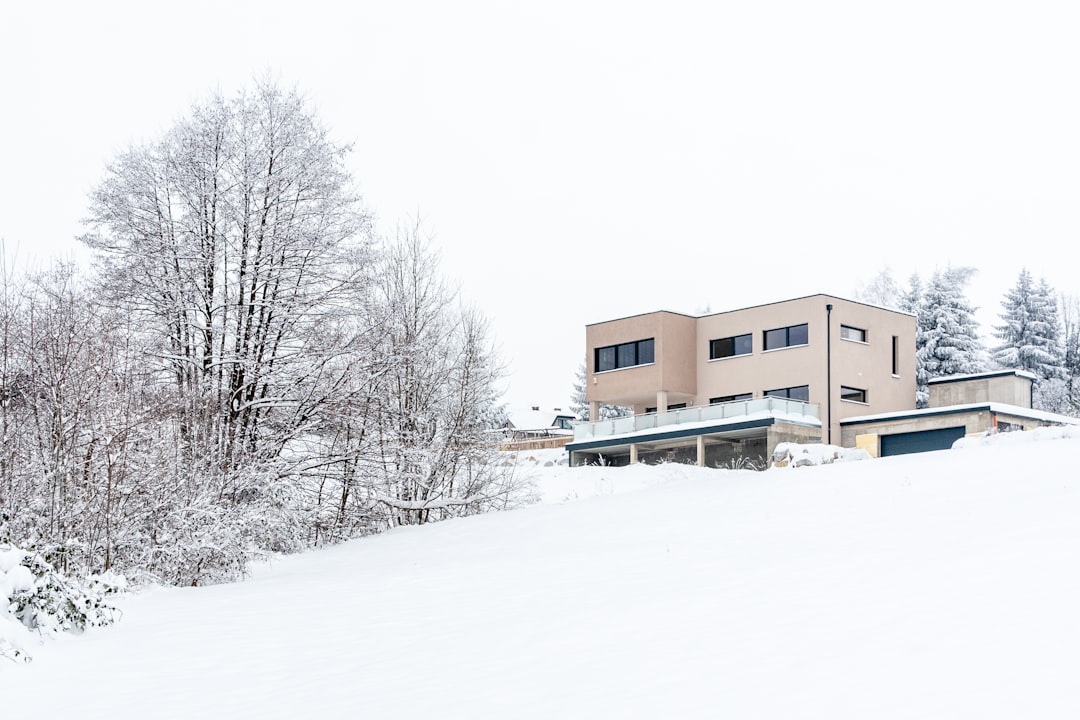 brown concrete building surrounded by snow covered ground during daytime