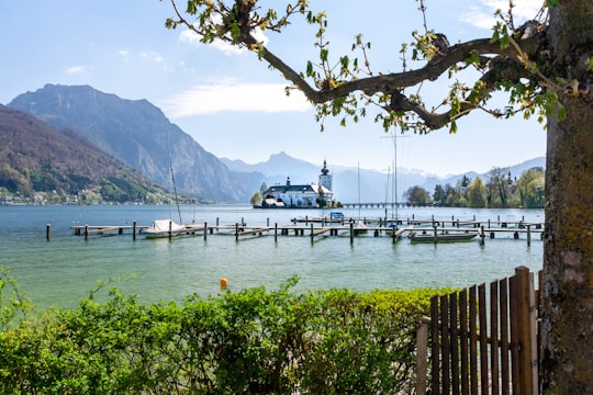 white boat on sea dock during daytime in Traunsee Austria