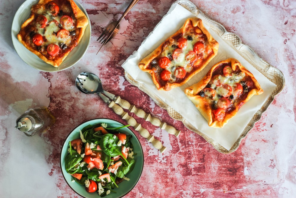 pizza on white ceramic plate beside stainless steel spoon