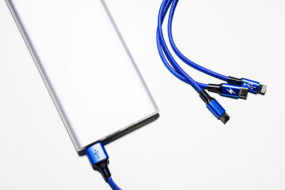 A portable power bank with a charging cable on a table