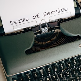 green and white typewriter with white paper