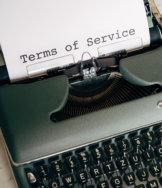 green and white typewriter with white paper