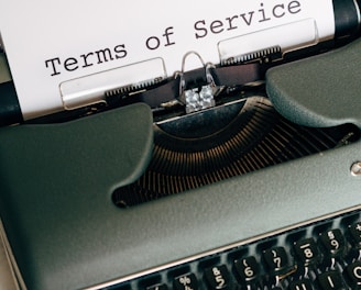 green and white typewriter with white paper