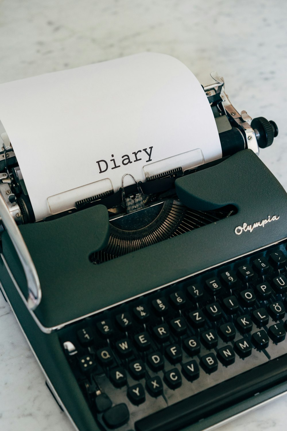 a black and white typewriter sitting on top of a table