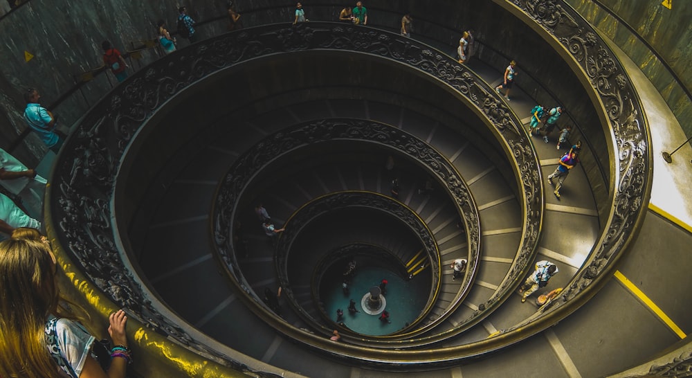 people walking on spiral staircase