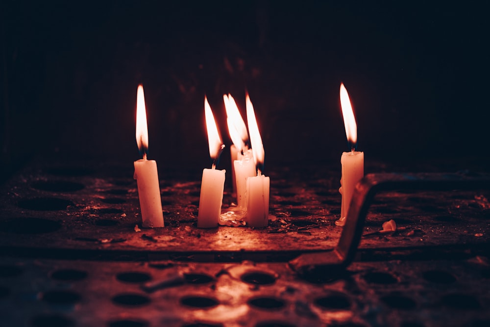 lighted candles on brown soil