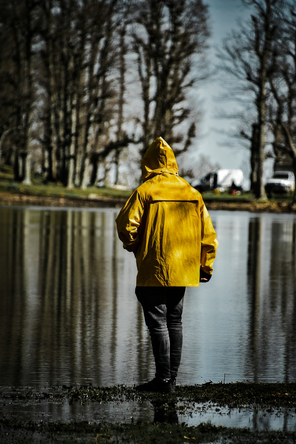 person in yellow hoodie standing on water