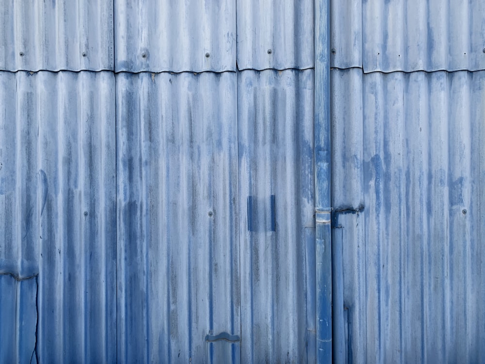 blue wooden door with black steel door lever