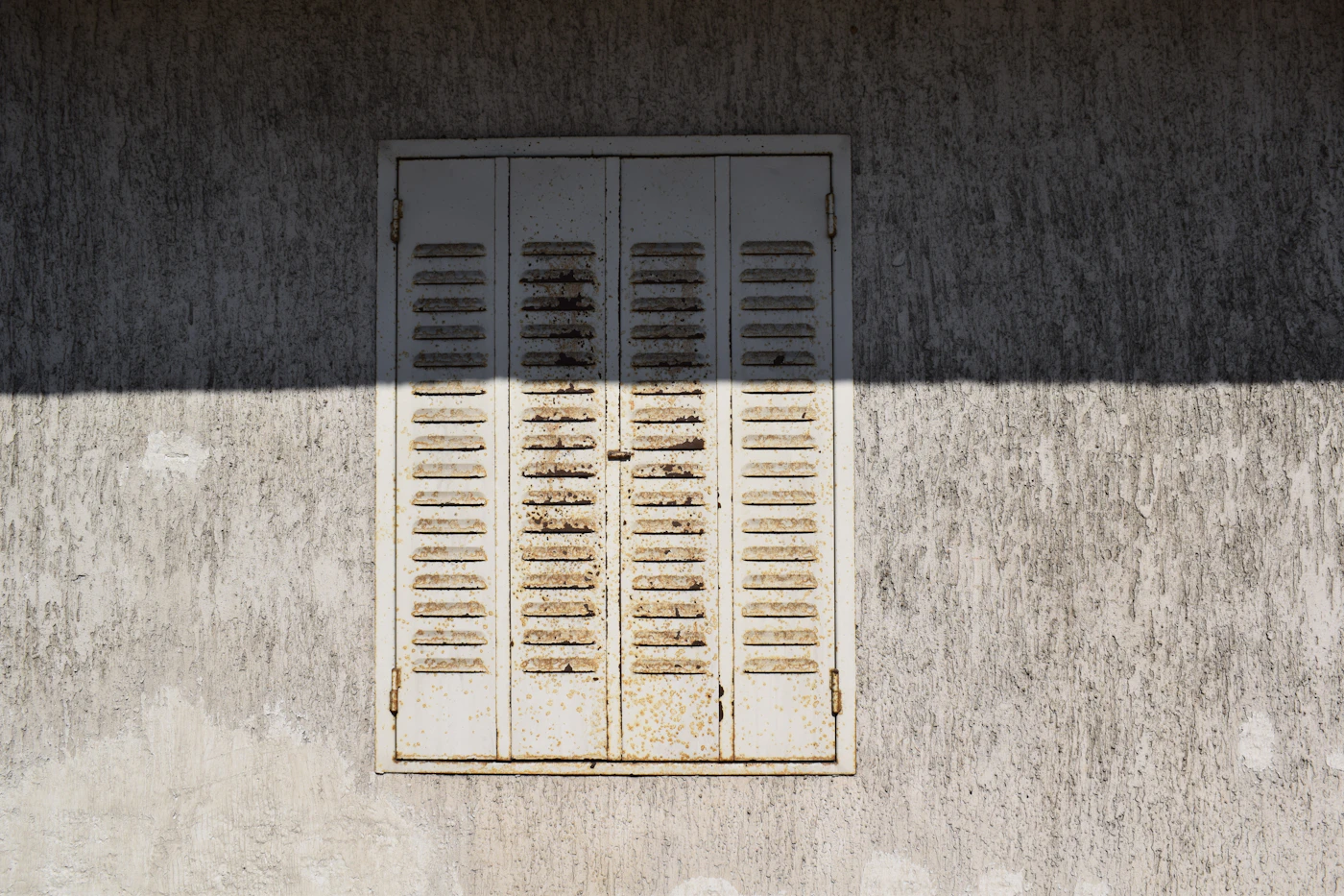 Metal storm shutter protecting an opening