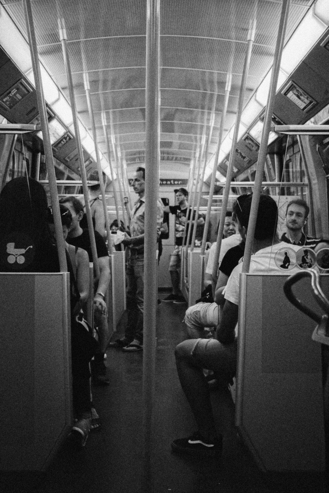 grayscale photo of people in train