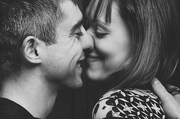 A close-up of a couple exchanging heartfelt smiles, capturing an intimate emotional moment.