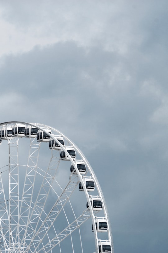 white ferris wheel under cloudy sky during daytime in Vieux-Port de Montréal Canada
