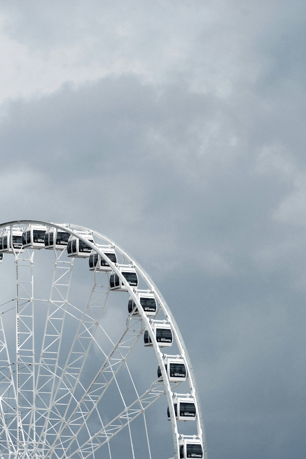 white ferris wheel under cloudy sky during daytime