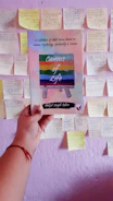 A hand holding a signed copy of the memoir with a personal note inside.