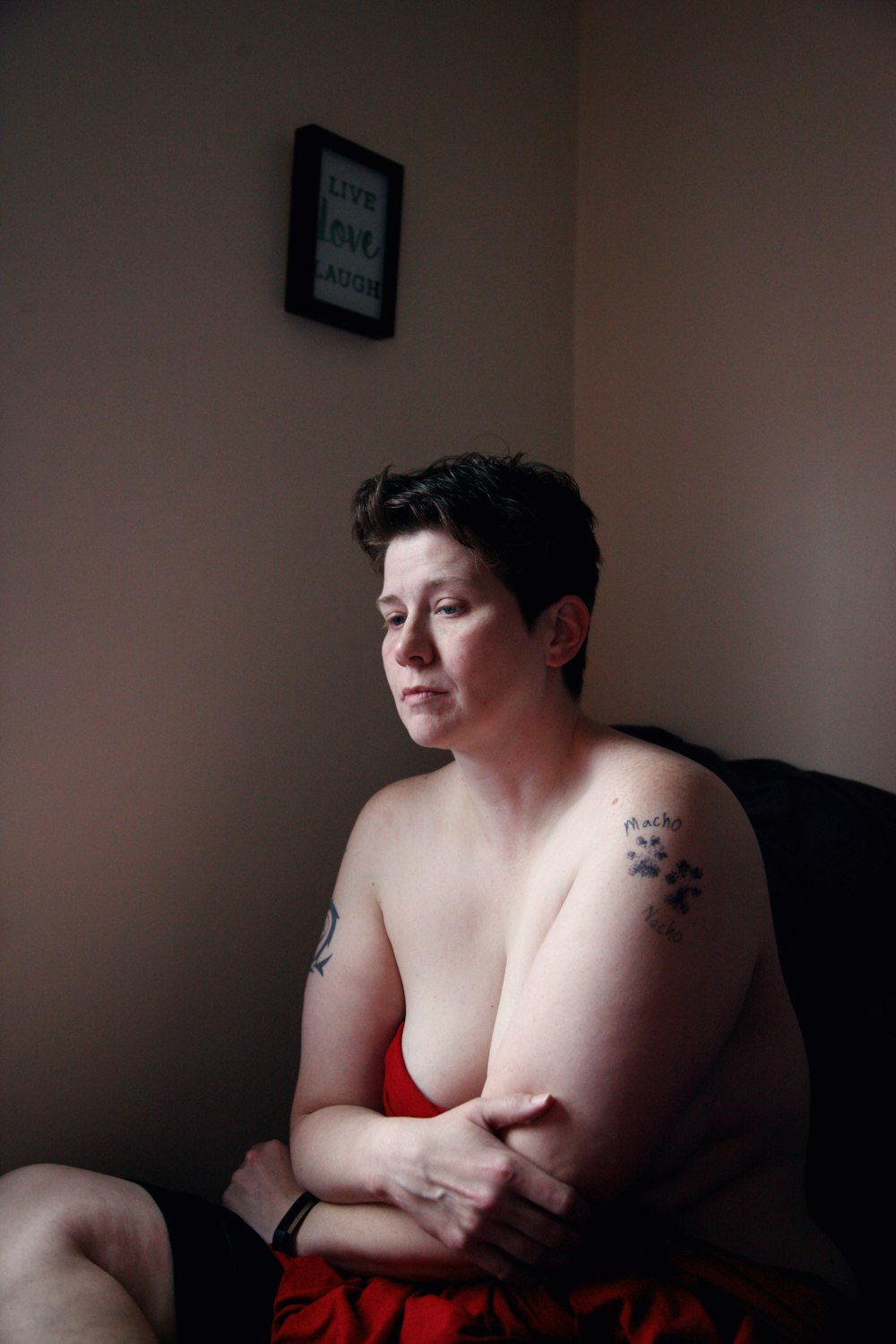 topless woman sitting on black couch