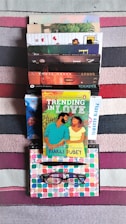 A stack of colorful books on a wooden desk, symbolizing knowledge and learning.