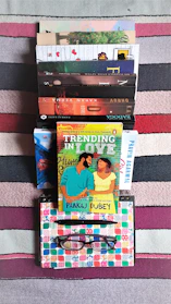 A vibrant stack of colorful healthcare books with a cozy reading nook in the background.