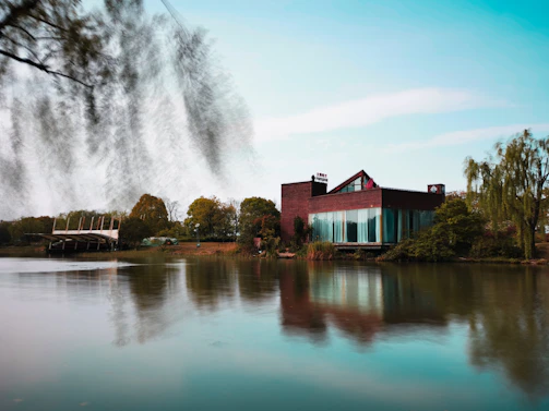 A scenic view of the Riverbend Valley office building nestled by the river, symbolizing stability and connection.