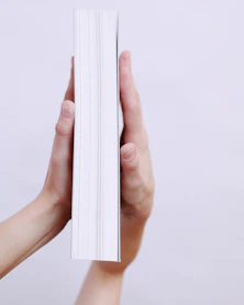 person holding white printer paper