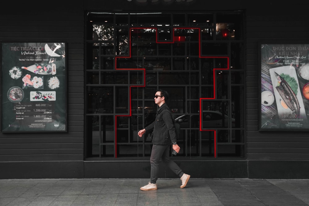 man in black suit standing in front of black building