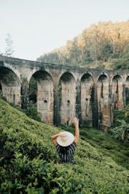 woman in black and white stripe long sleeve shirt standing on green grass field during daytime