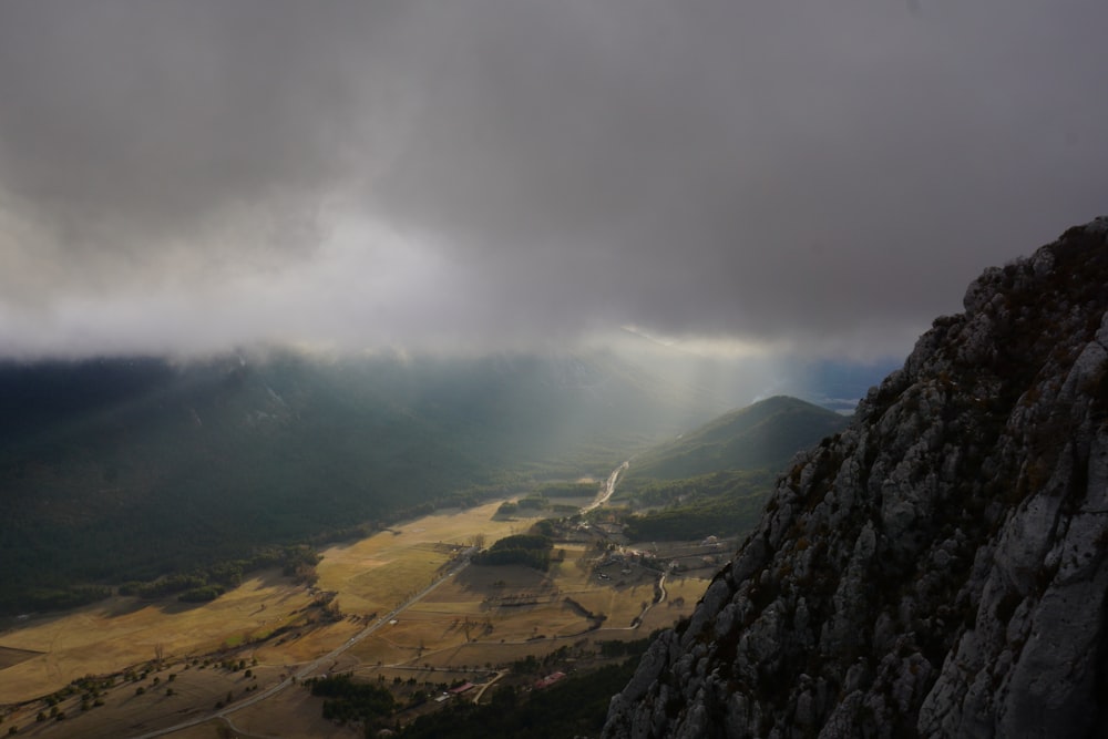 aerial view of mountains under cloudy sky during daytime