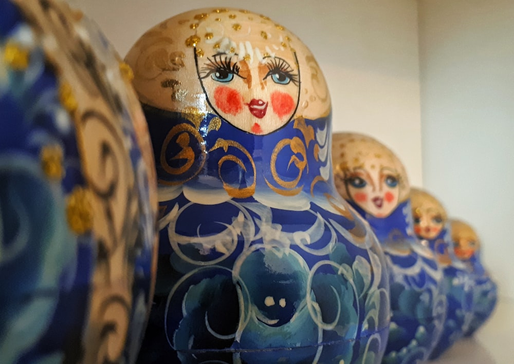 a group of blue and gold vases sitting on top of a table