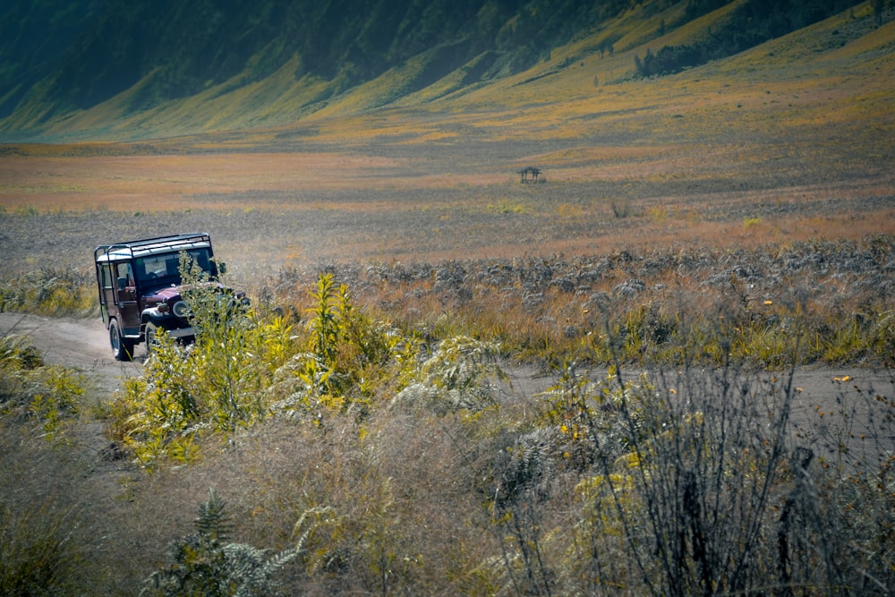 black suv on brown grass field during daytime