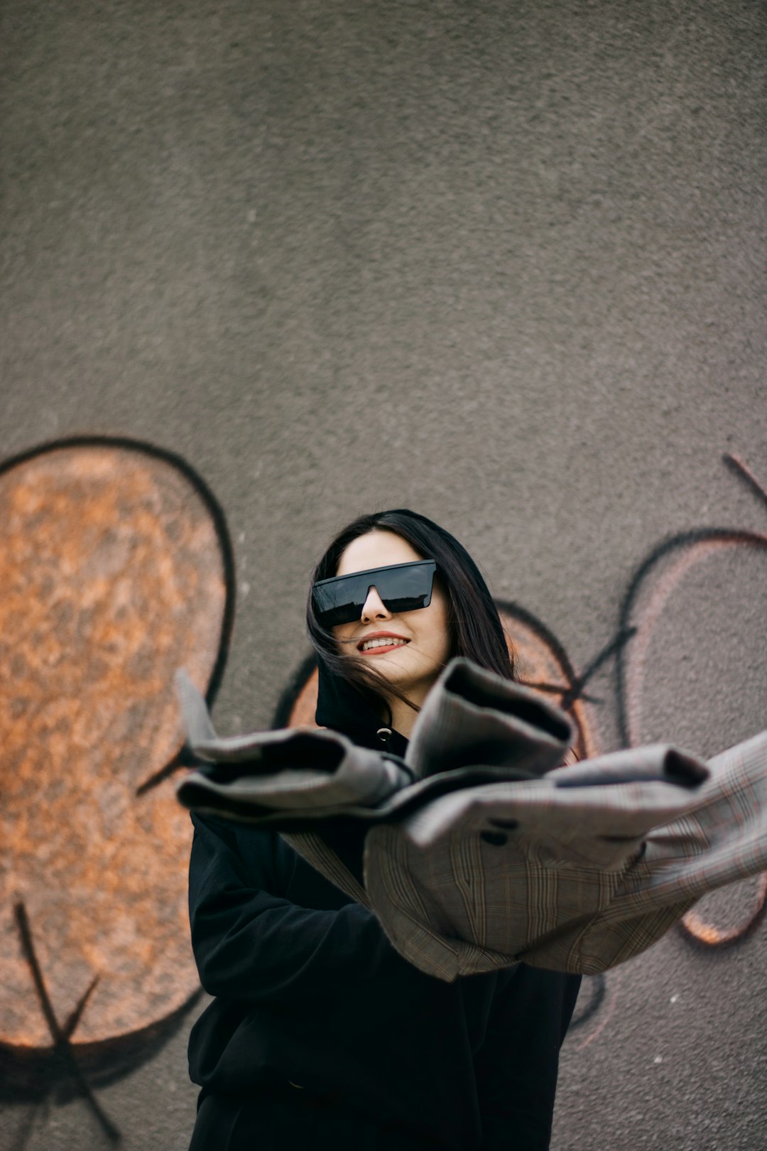 woman in gray jacket wearing black sunglasses