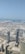 An aerial view of a modern city with highlighted geospatial data overlays.