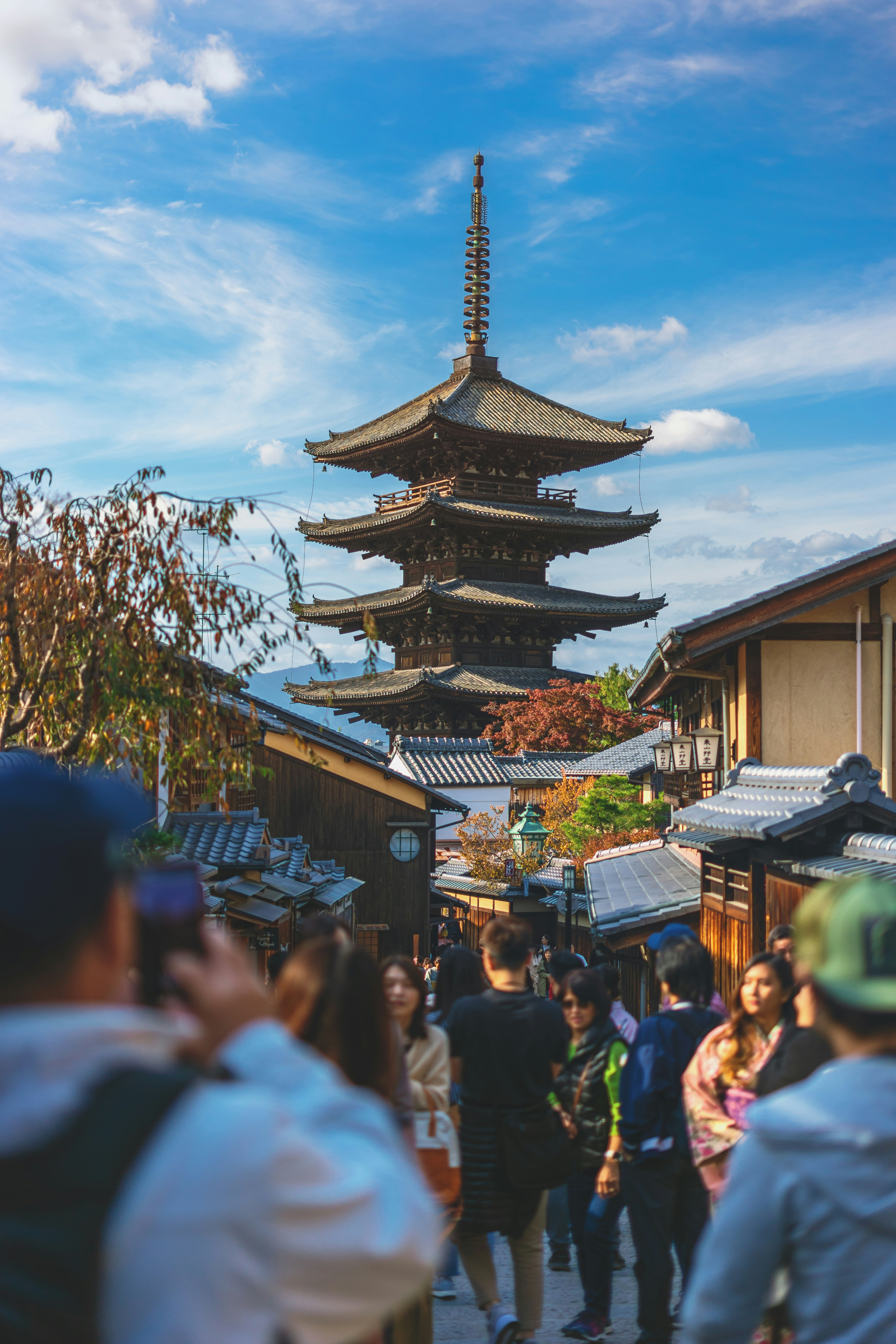 people walking on street near brown and black house during daytime