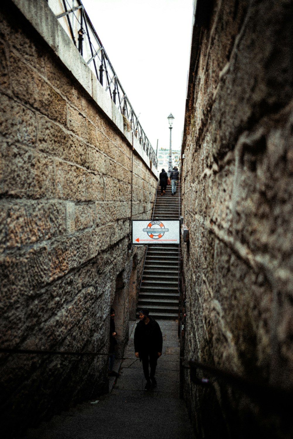 man in black jacket walking on the stairs