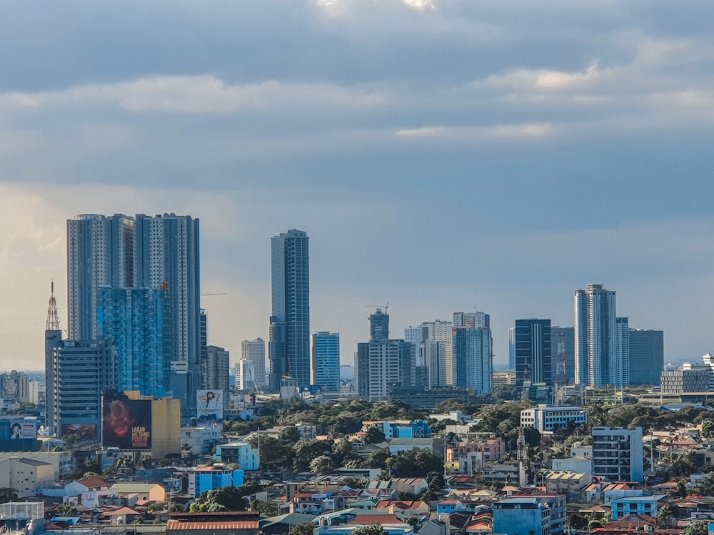 city skyline under white clouds during daytime